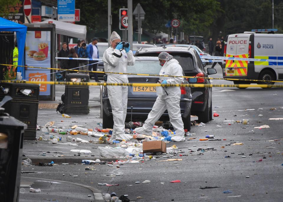  Forensic officers take photographs at the scene