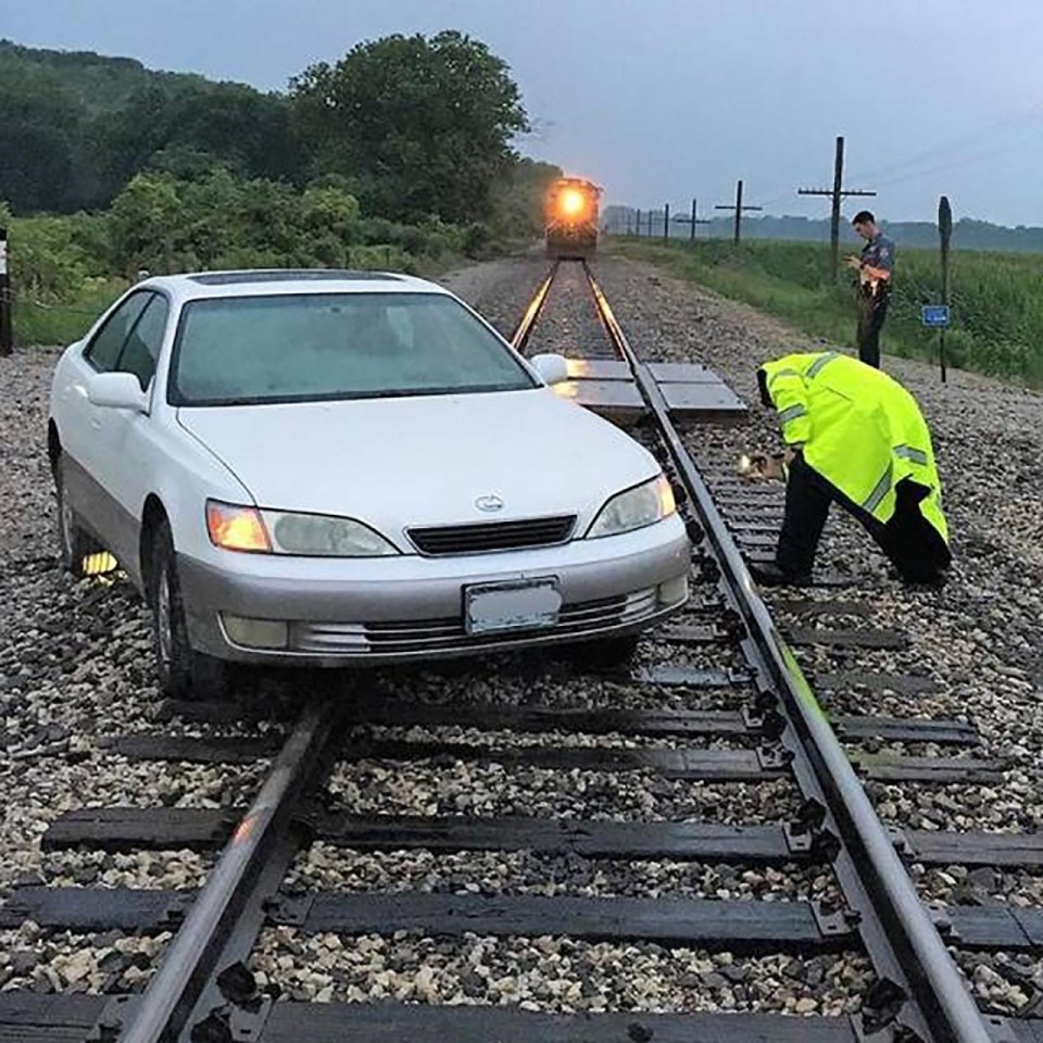 When a car found itself on the railway tracks, it was very nearly collected by an oncoming train