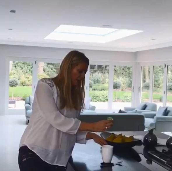  The white and grey decor leads through to the kitchen which has an island in the middle