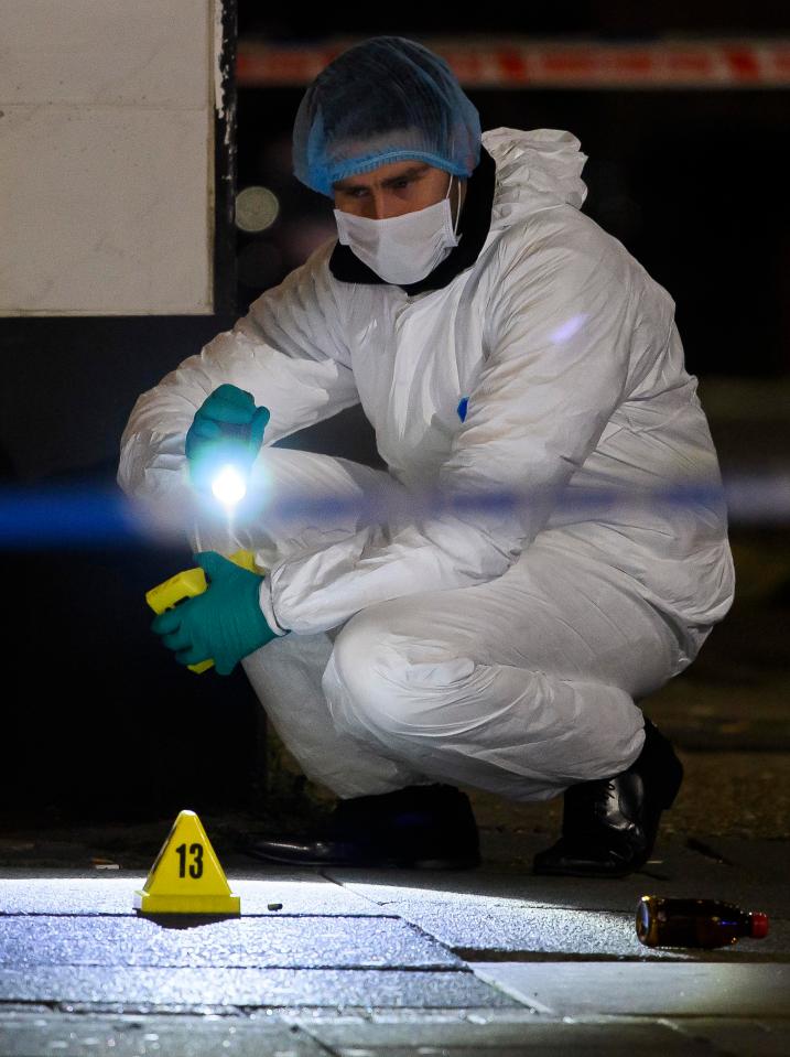  Forensics examine a bullet casing after the triple shooting