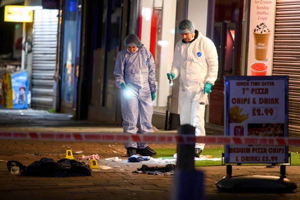  Forensics examine the scene of the shooting