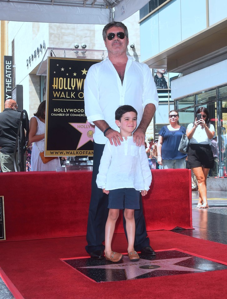 Simon beamed alongside his sweet son Eric during the happy occasion