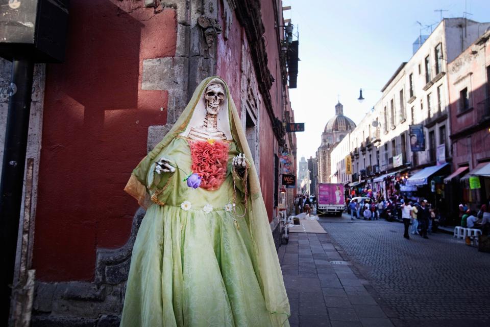  At the festival of Santa Muerte in Mexico, tourists gather to see worshippers pay respects to a skeleton in a ceremony celebrating death