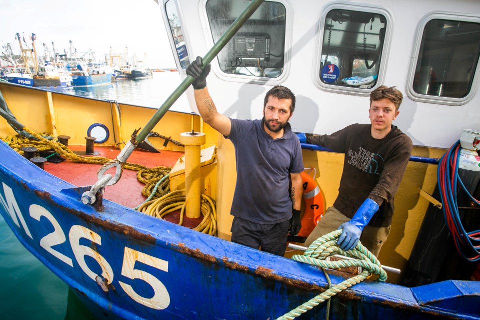 Fishermen Callum Clark and Nathan Clark onboard Joanna C at the Brixham Harbour in Devon. They vowed to defiantly return to the water later this week