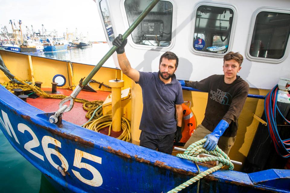  Fishermen Callum Clark and Nathan Clark onboard Joanna C at the Brixham Harbour in Devon. They vowed to defiantly return to the water later this week