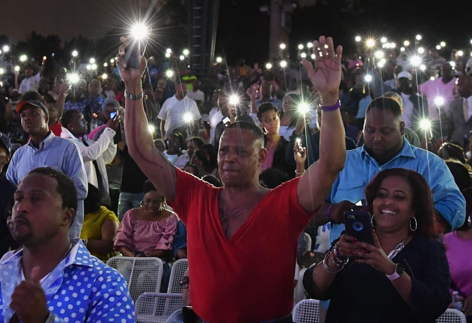 People hold up their lit mobile phones during ‘A People’s Tribute to the Queen’ concert last night