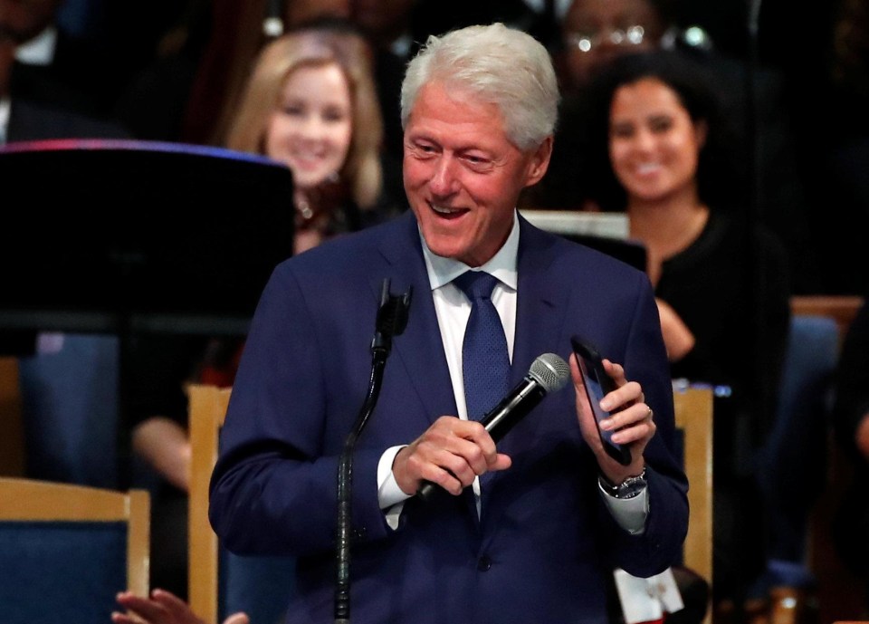 Bill Clinton plays Aretha Franklin music on his mobile phone while speaking at the funeral service