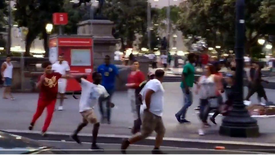  A street trader is seen whipping the American tourist with a belt during the melee