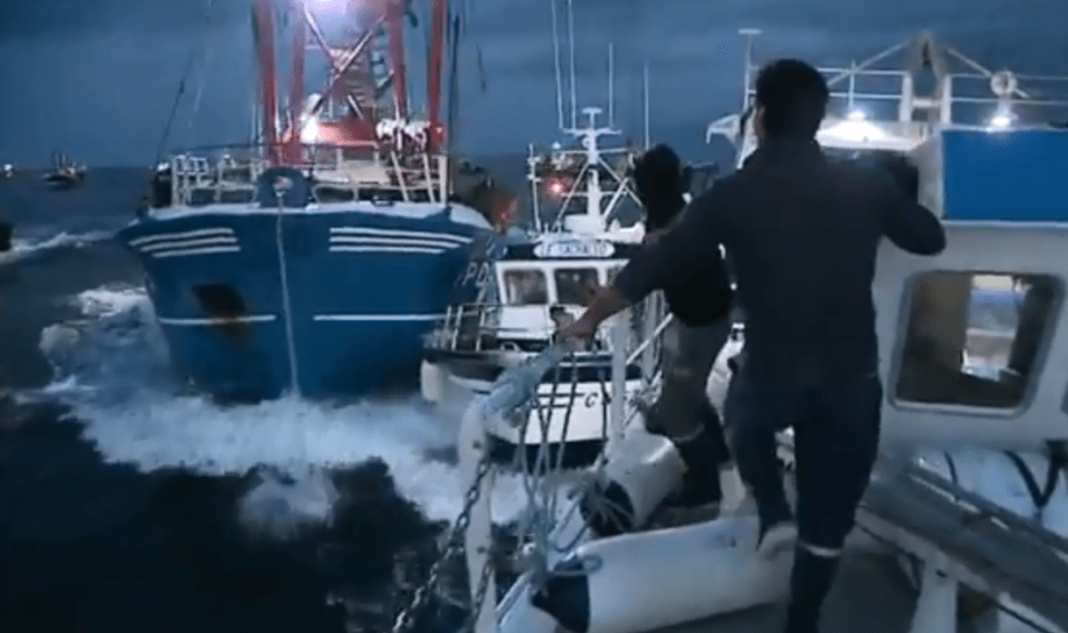 A tiny fishing boat was nearly crushed between two larger ones during the war over scallops