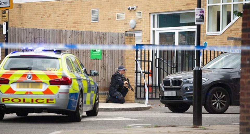  An armed officer was seen crouching outside the school in West London today