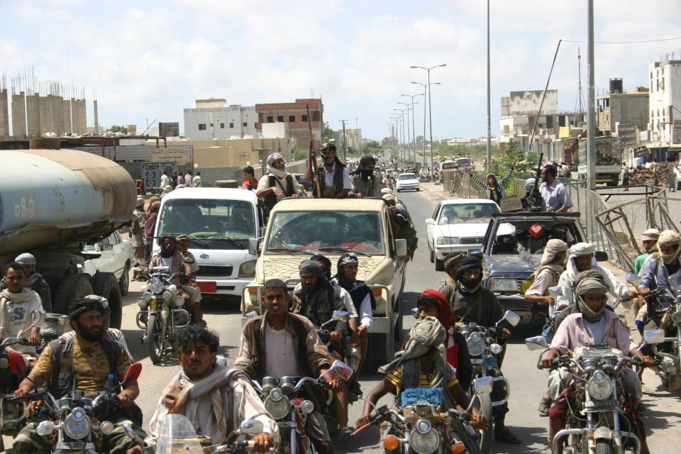  Yemeni militants, suspected of being members of Al-Qaeda patrol on their pick ups in the restive southern city of Zinjibar in Abyan province