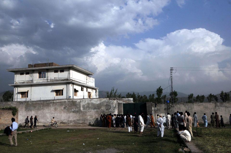  Local residents gather outside the sealed entrance to the compound where US military forces killed Osama Bin Laden, the leader of Al-Qaeda network, in Abbottabad, Pakistan on 04 May 2011