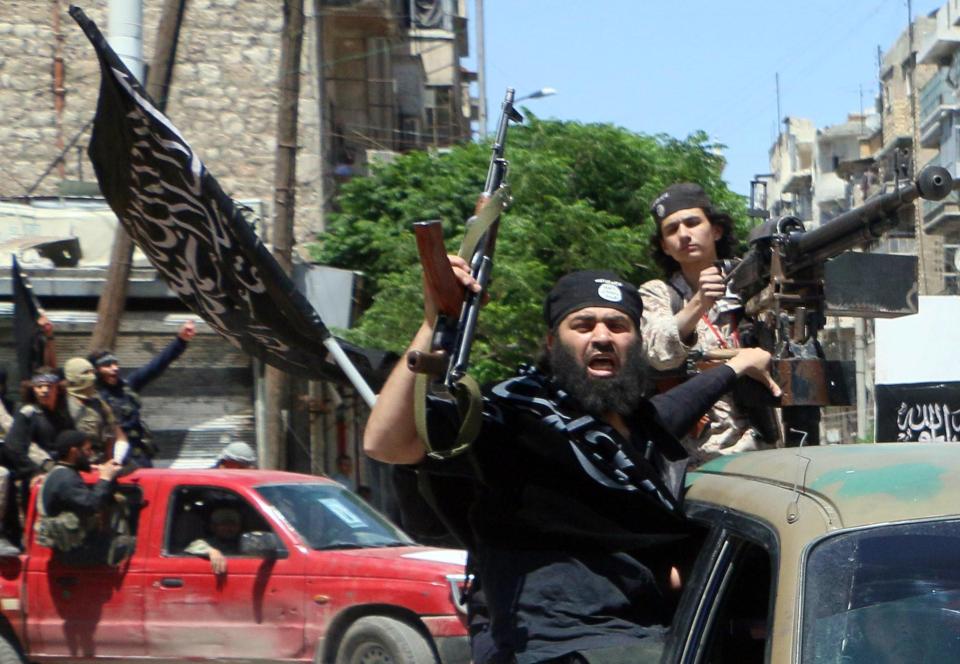  Fighters from Al-Qaeda's Syrian affiliate Al-Nusra Front drive in the northern Syrian city of Aleppo