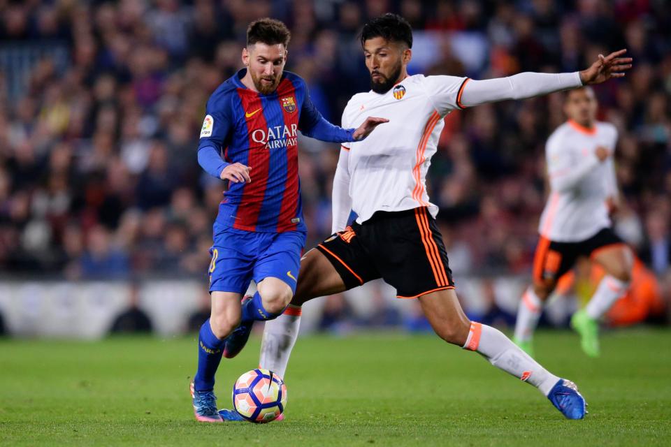  Garay, tackling Lionel Messi, plays for Spanish club Valencia