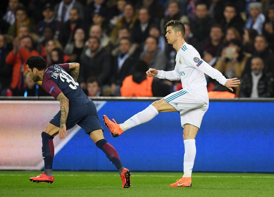  Ronaldo kicks out at Dani Alves during a Champions League game