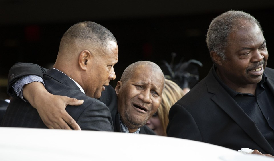 Clarence Franklin (centre) mourns for his mother