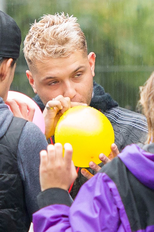 Rafferty appeared to be sucking on the balloon as he hung about with his pals in West London