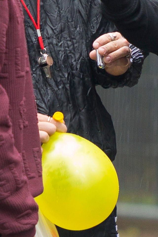 In one hand he was holding what appeared to be a canister which contains the gas which can be put into the balloons