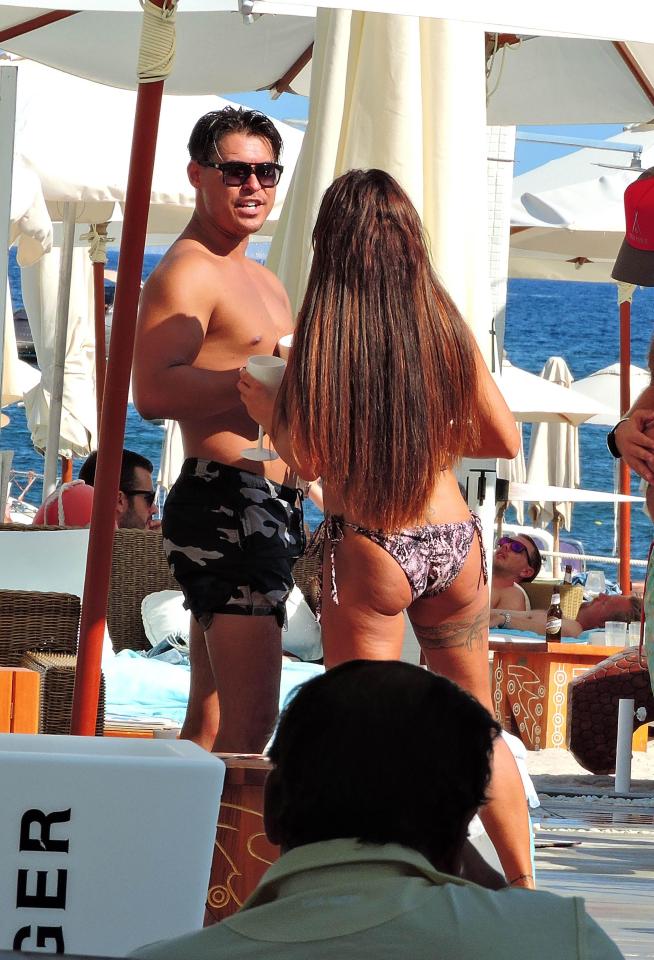  She showed off her perky bum and famous assets in an animal print bikini