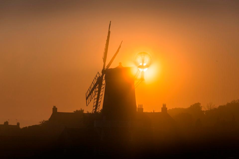  The sun shines through the Fantail of the 19th century Cley Windmill this morning in Cley next the Sea on the Norfolk coast. This summer was the hottest in England since records began