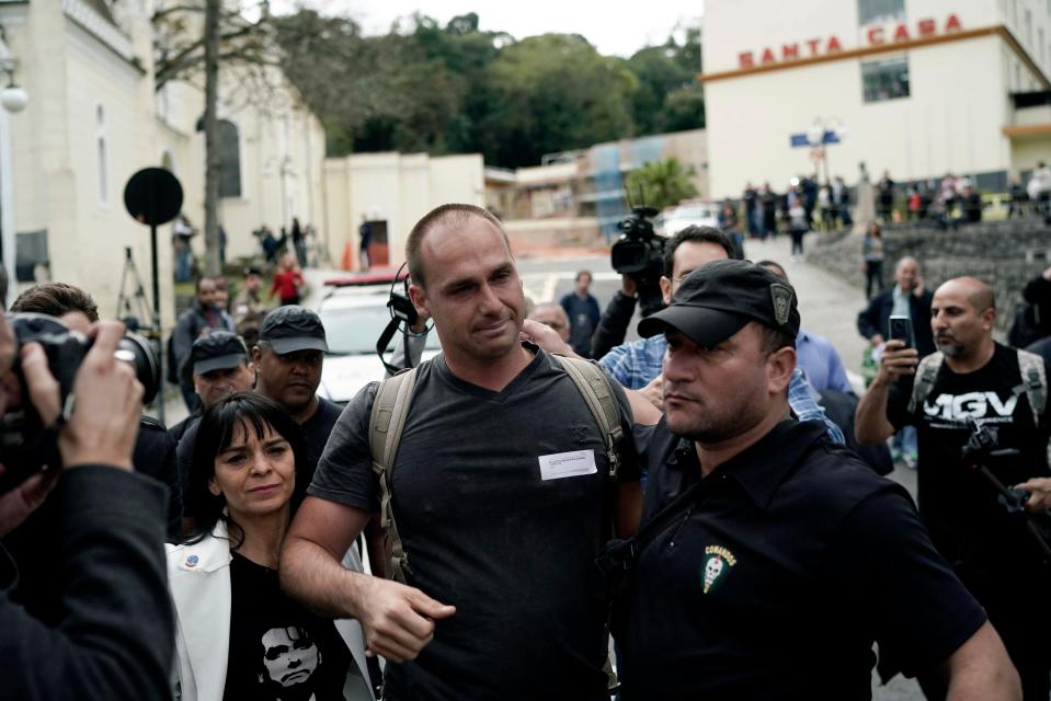  Eduardo Bolsonaro, son of presidential candidate Jair Bolsonaro is greeted by a supporter as he arrives at the Santa Casa hospital