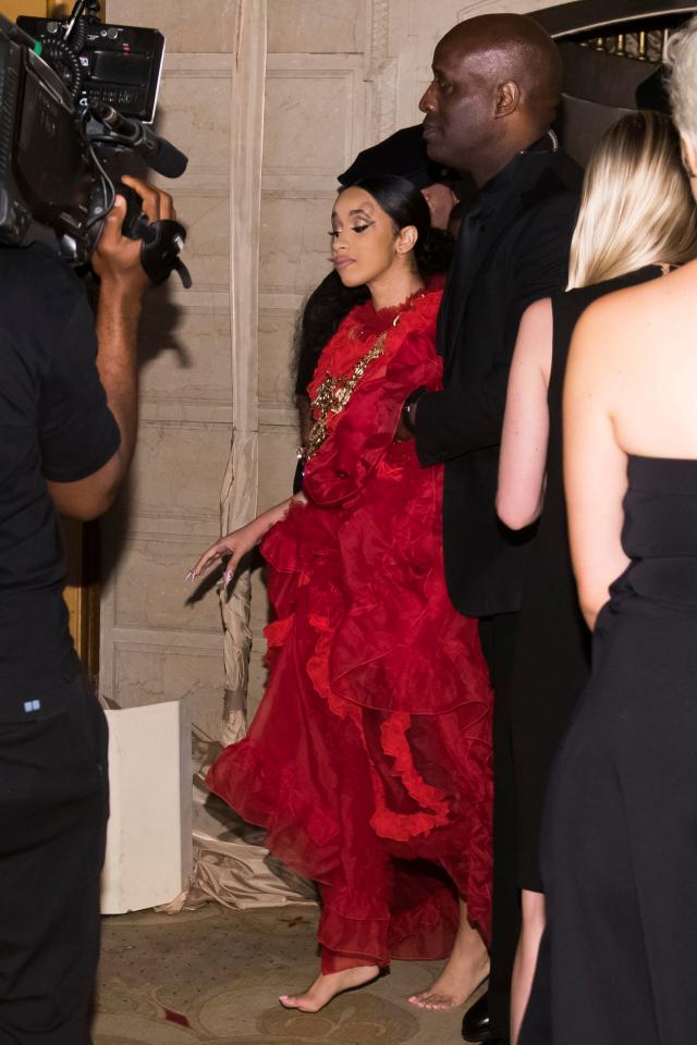  Cardi is led from the venue minus her shoes - which she threw during the fight