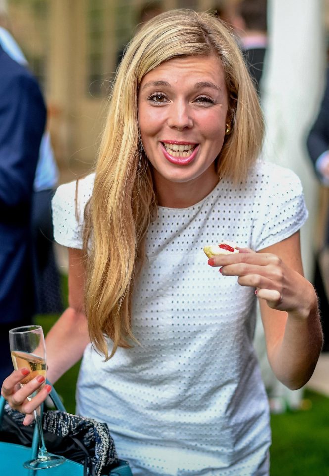  Blonde ex-Tory aide Carrie Symonds, 30, cheekily poses for the camera with a tasty treat