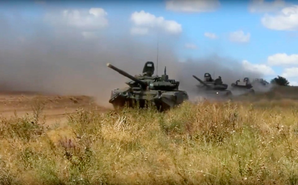 Russian tanks plough across farmland as the war games kick off in Siberia in September