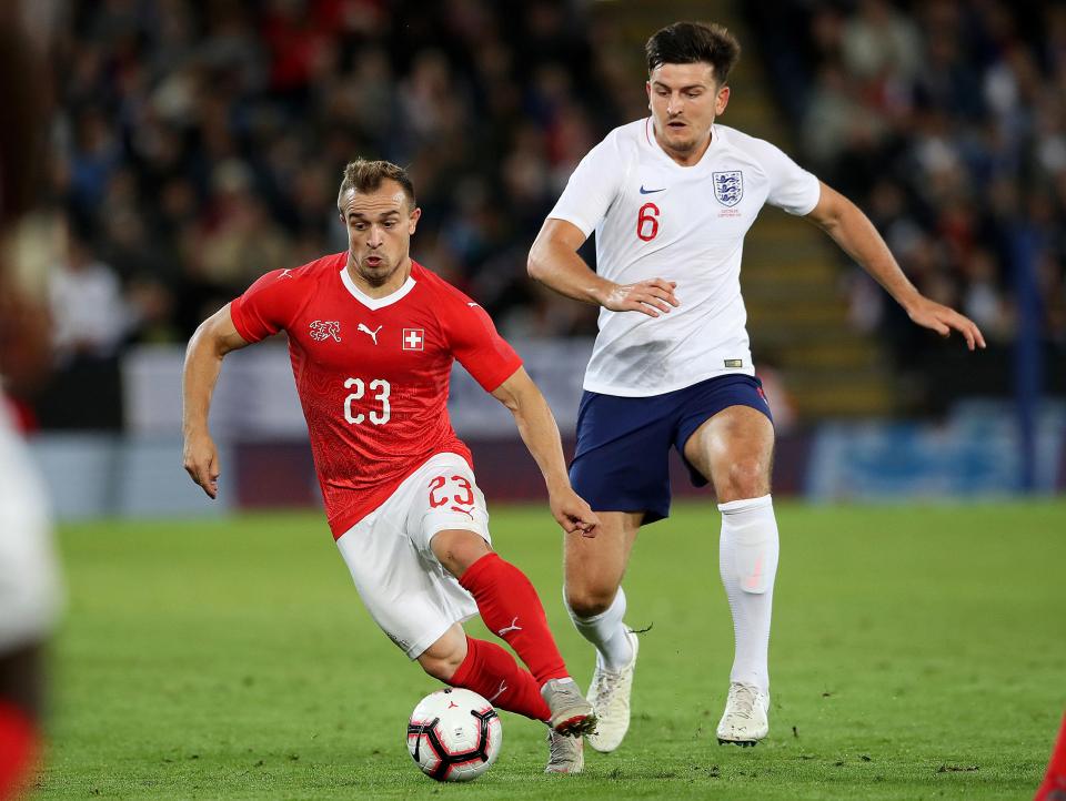  Harry Maguire towers over Shaqiri during the clash