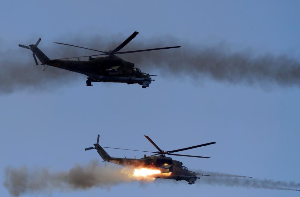  Military helicopters fire their missiles during one of the mock air battles put on for Putin