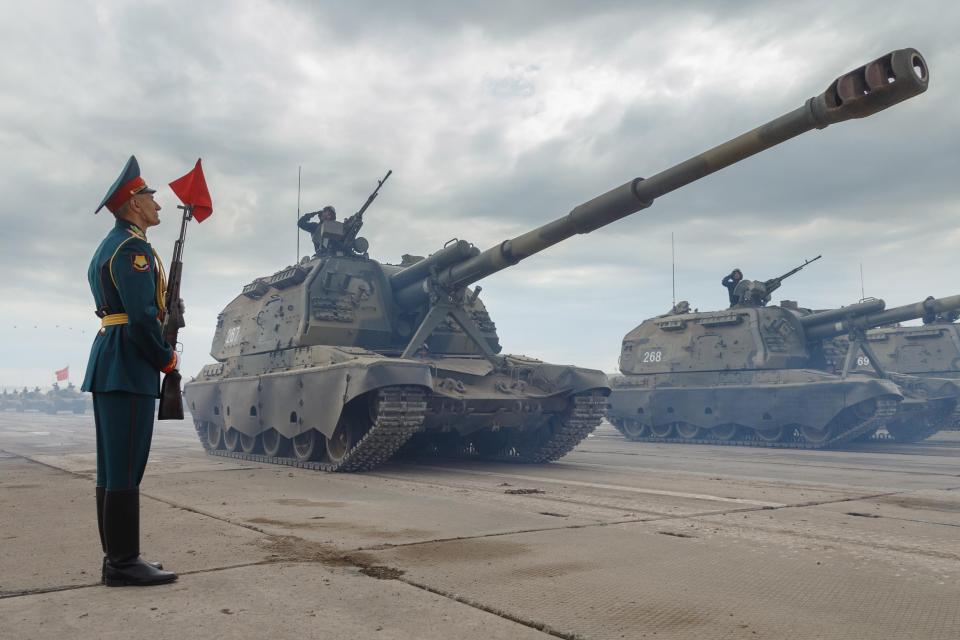  A soldiers stands on parade as tanks parade for Putin