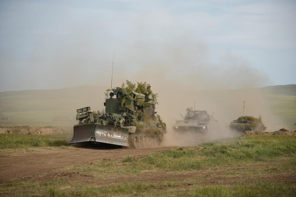  A Russian mine clearer careers across open farmland in Siberia during the five-day drills