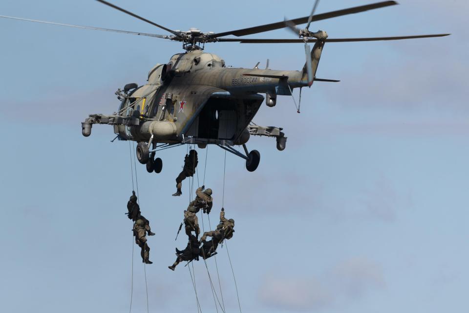  Servicemen fast-roping from a Mil Mi-8AMTSh-V multi-purpose helicopter