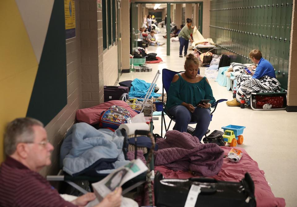  Locals wait in an evacuation shelter set up at the Conway High School in North Carolina