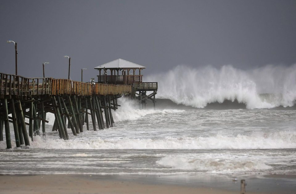  Waves crash around the Oceana Pier as the outer edges of Hurricane Florence hit the US