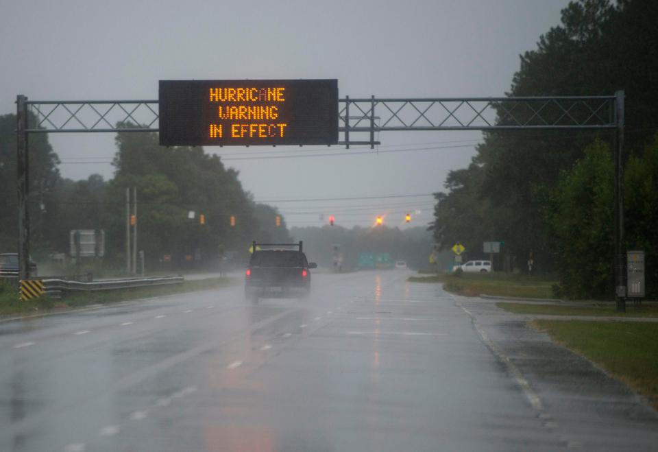  Cars drive through wet roads as rain from Hurricane Florence falls in Wilmington