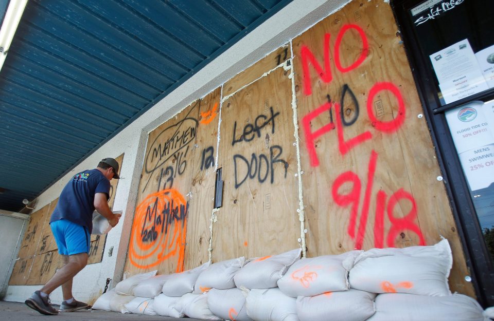  Spray-painted messages are seen on boarded up businesses ahead of the storm