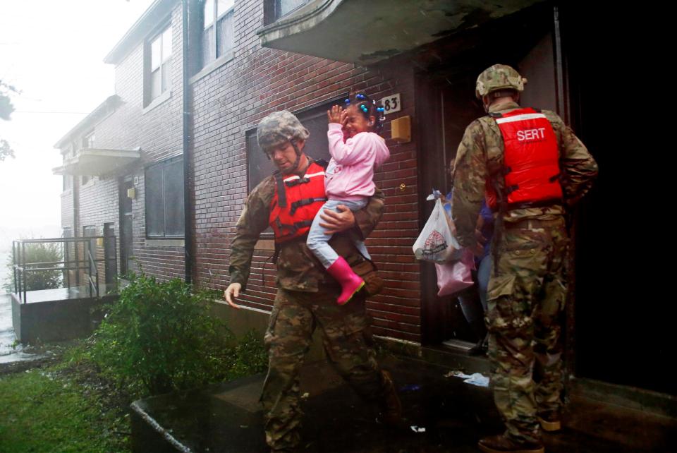  A rescue team from the North Carolina National Guard evacuates a family as the rising floodwaters threatens their home in New Bern, NC