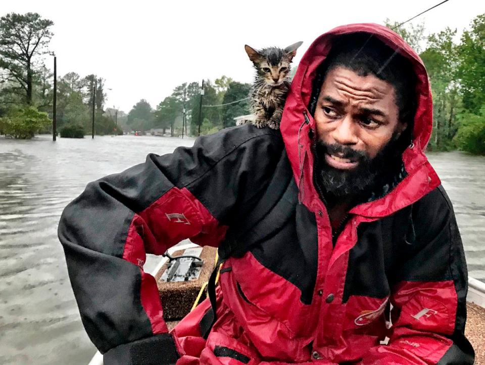  Robert Simmons Jr. and his kitten Survivor are rescued from floodwaters after Hurricane Florence dumped several inches of rain in the area overnight