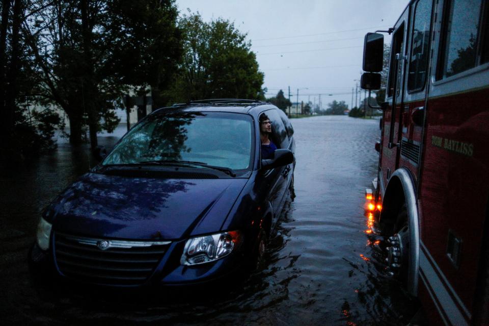  People wait to be rescued from a car trapped in floodwaters in North Carolina