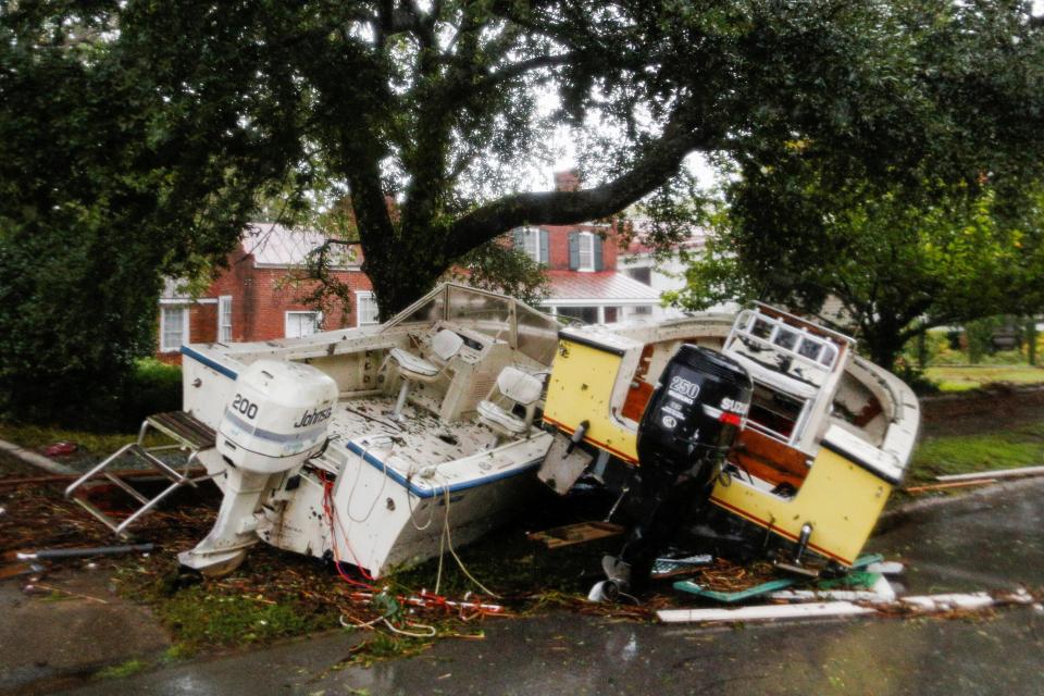  Boats pushed away from the dock are seen on a street in New Bern