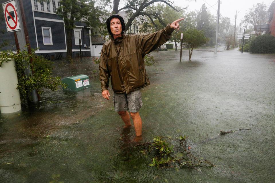  A man walks through flooded streets in North Carolina after the deadly storm hit