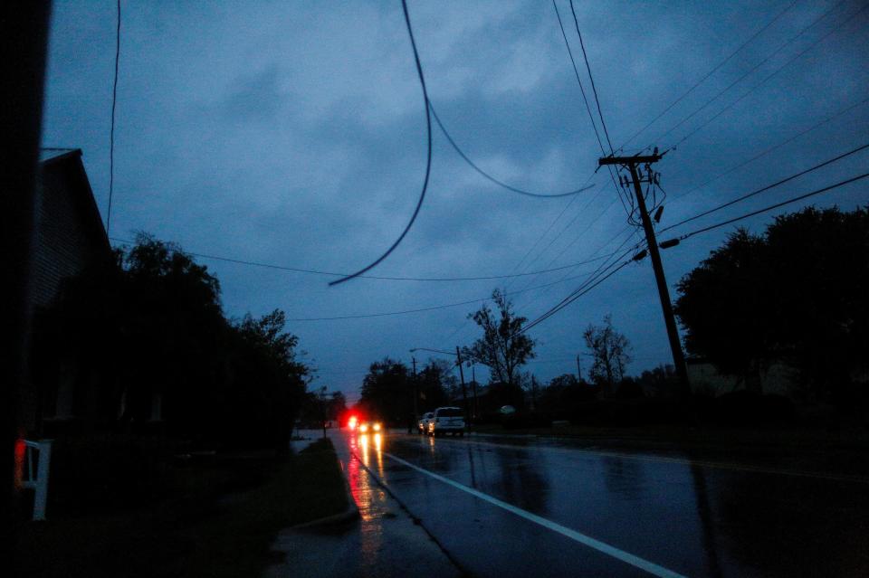  Power lines are seen hanging from a post in New Bern, North Carolina