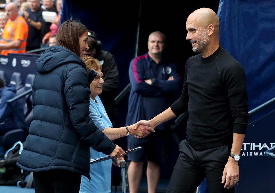  Pep Guardiola, right, shakes hands with Olga