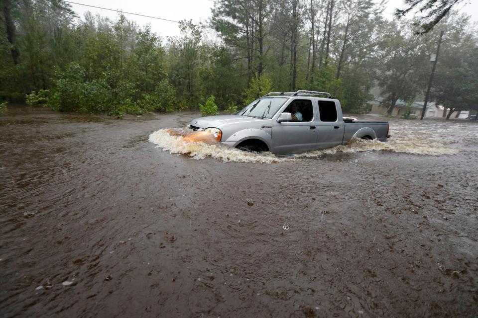  A motorist drives through high waters after Hurricane Florence swept through, in Bolivia, North Carolina