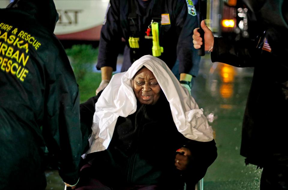  Ernestine Crumpler, 80, is helped by a search and rescue team as they evacuate an assisted living facility in Fayetteville