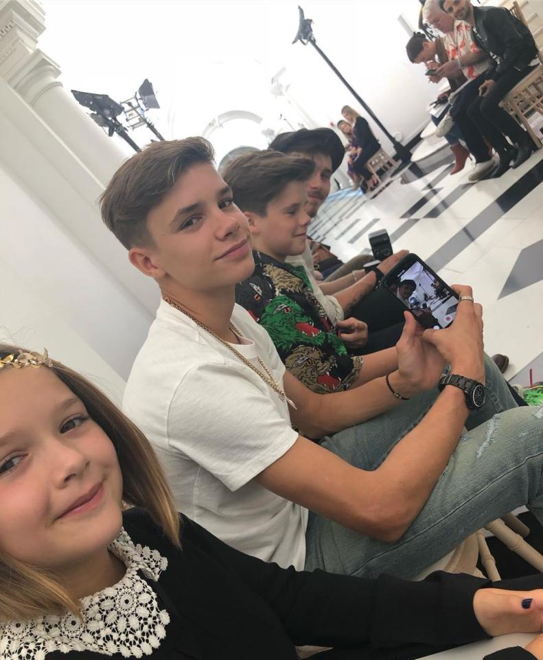  Sitting front row for their mother's LFW debut, the Beckham children use it as an opportunity for a quick selfie