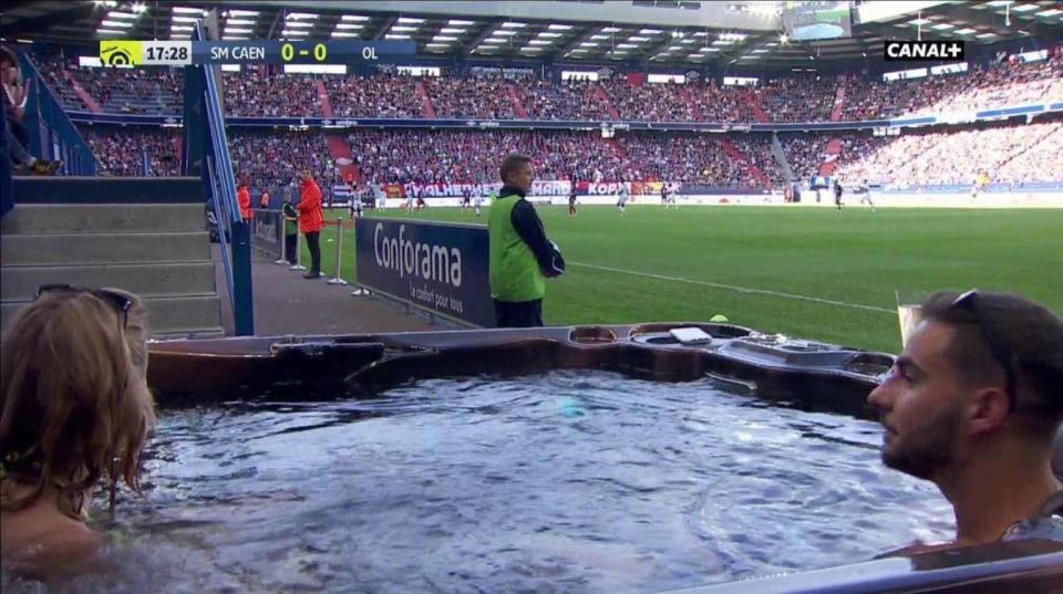  Two Caen fans watched their team take on Copenhagen from a hot tub