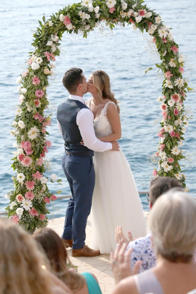  Bride Rhian Sugden and groom share a romantic kiss by the sea