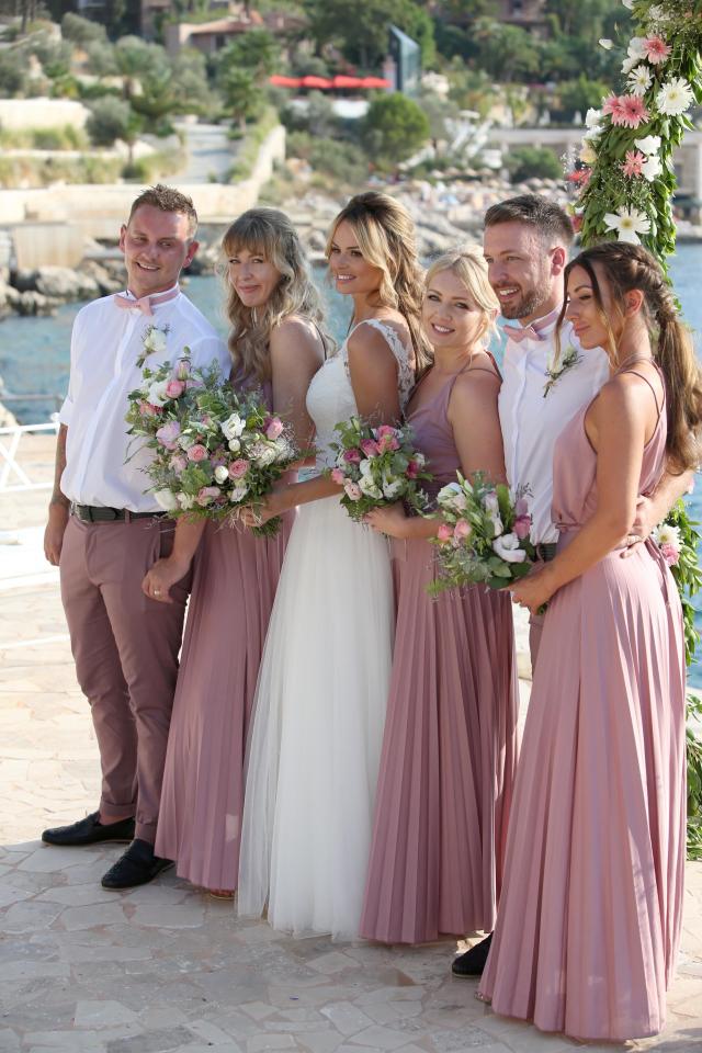  Bridesmaids all crowd around blushing bride Rhian Sugden